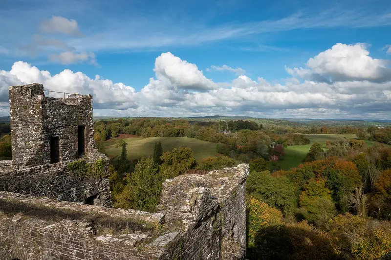 Dinefwr Castle: Dinefwr Castle is a ruined castle overlooking the River Tywi near the town of Llandeilo, Carmarthenshire, Wales. It lies on a ridge on the northern bank of the Tywi